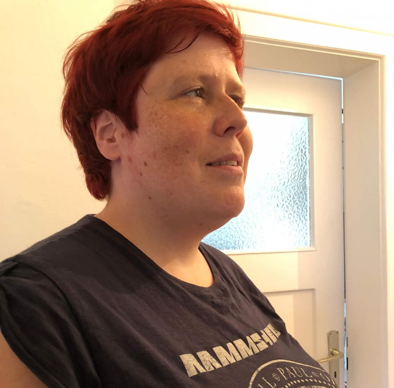 Nainen, jolla lyhyet punaiset hiukset ja Rammstein-yhtyeen t-paita.